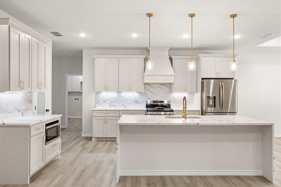 Culinary delights await in this bright kitchen with a spacious island, premium appliances, and ample counter space. Culinary delights await in this bright kitchen with a spacious island, premium appliances, and ample counter space.