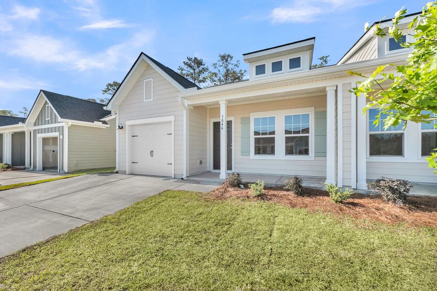 Front exterior of a new home in Tea Farm, Ravenel, SC, highlighting curb appeal (Image 16). Front exterior of a new home in Tea Farm, Ravenel, SC, highlighting curb appeal (Image 16).
