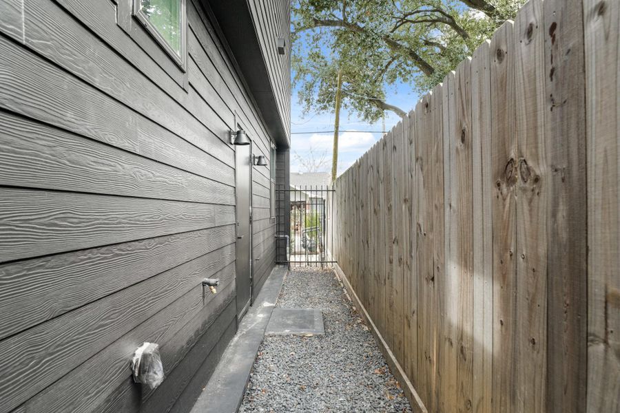 The exterior setup is thoughtfully finished with two coach lights for ambiance, while the wrought iron fence provides privacy. The exterior setup is thoughtfully finished with two coach lights for ambiance, while the wrought iron fence provides privacy.