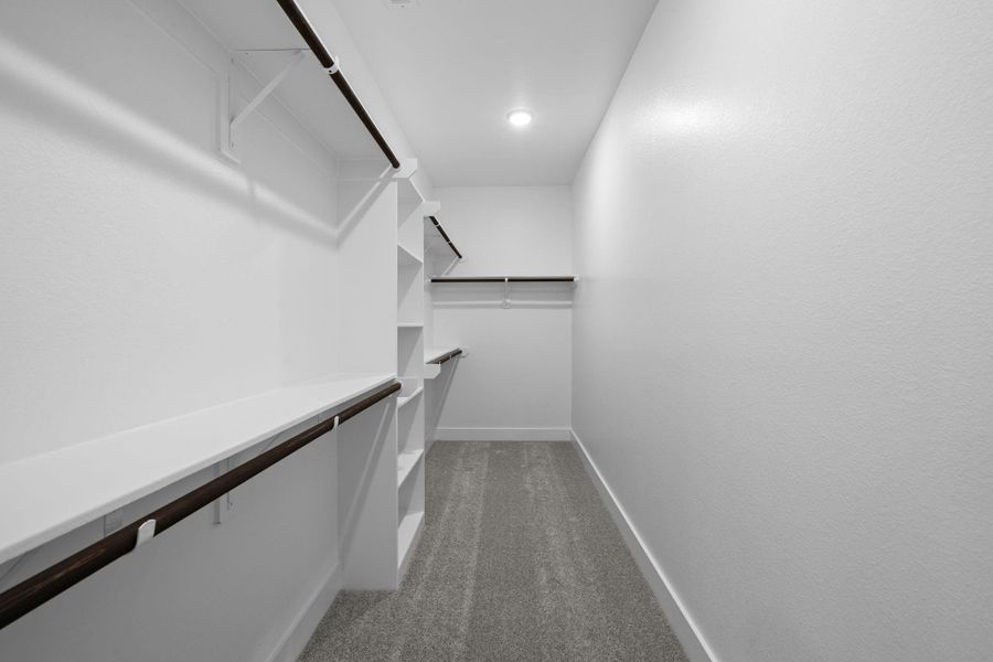 This closet features ample hanging space, and chic shoe racks or storage shelves, ensuring that everything has its place.