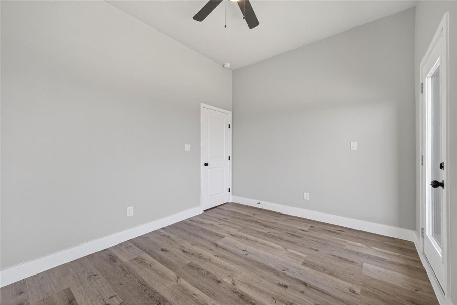 Alternate bedroom angle highlighting clean architectural lines, neutral designer paint tones, and durable plank laminate flooring designed for low maintenance and long-term beauty.