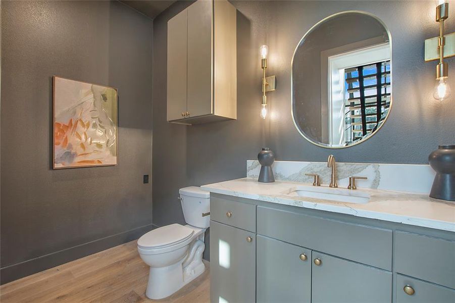 Bathroom with vanity, wood-type flooring, and toilet