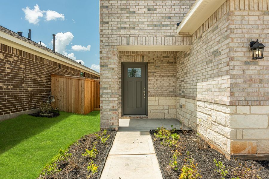 Front exterior of a new home in Stonebrooke, Conroe, TX, highlighting curb appeal (Image 2).