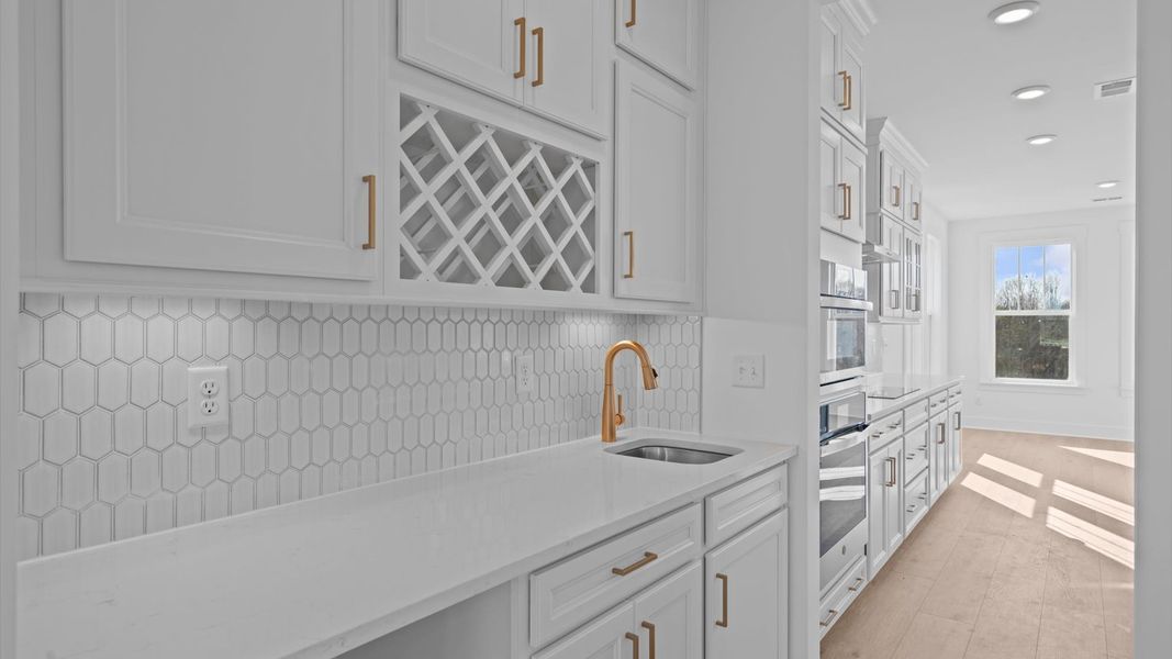 An exclusive butler’s pantry with wet bar, designed for stylish entertaining and effortless service.