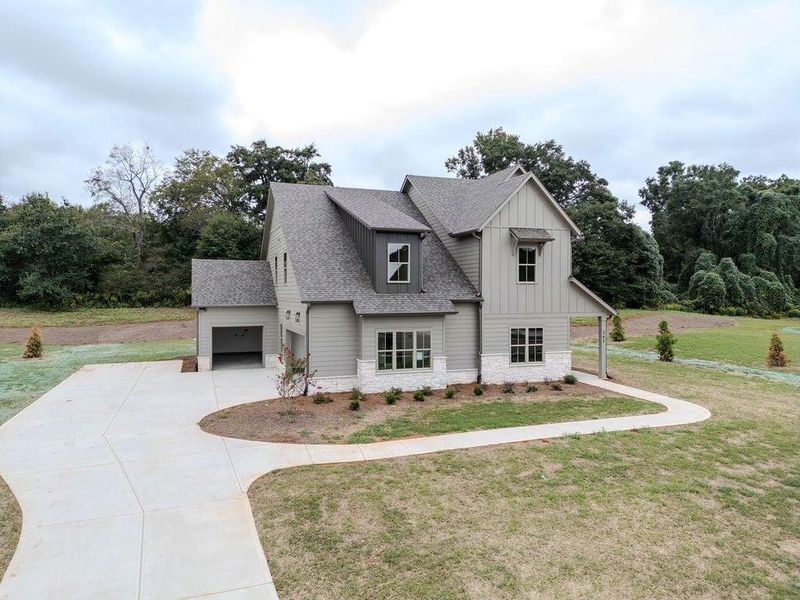 Front exterior of a new home in , Hoschton, GA, highlighting curb appeal (Image 28).
