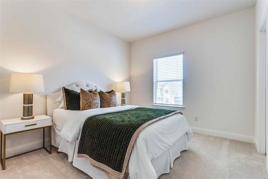 Bedroom featuring light carpet