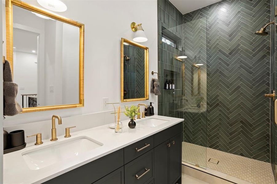 Bathroom featuring a dual vanity with undermount sinks, white countertop, and dark cabinetry