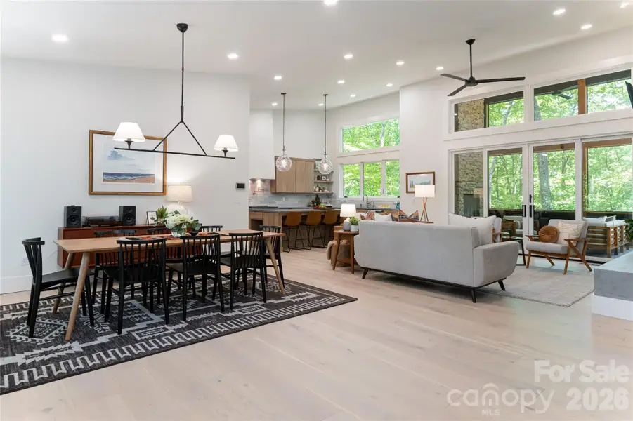Wide open floor plan with soaring ceilings and windows that flood the area with light