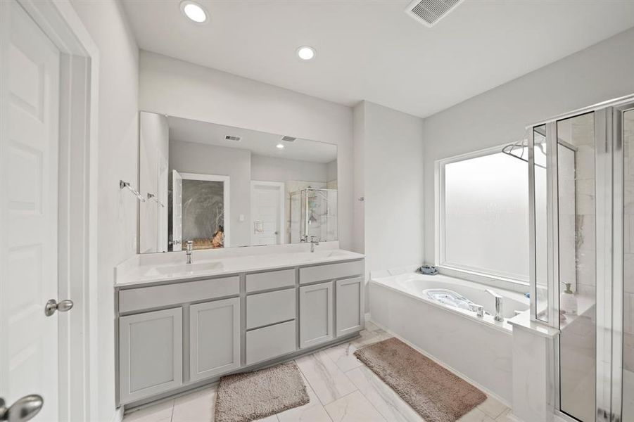 Dual vanities in your primary bath, offer personal space with tons of dedicated cabinet space.