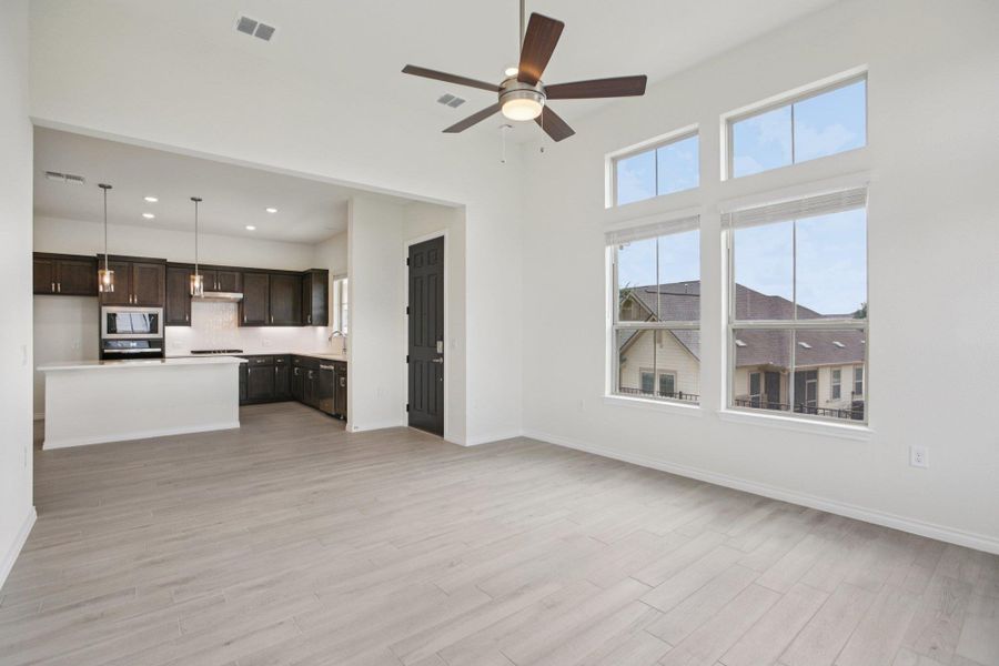 Unfurnished living room featuring light wood-type flooring, ceiling fan, and recessed lighting