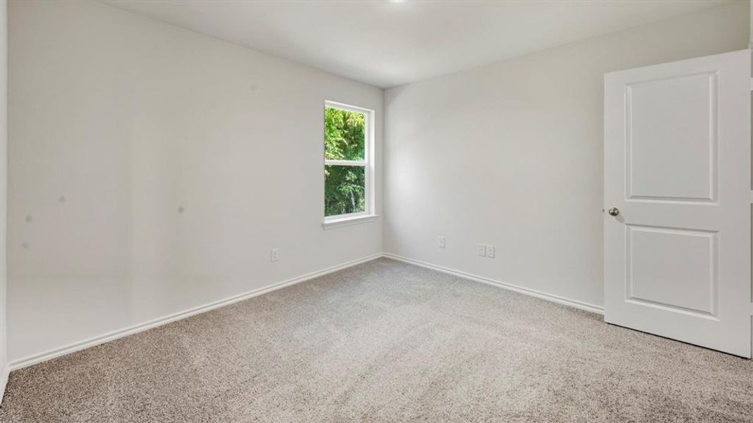 Unfurnished room featuring light colored carpet and baseboards
