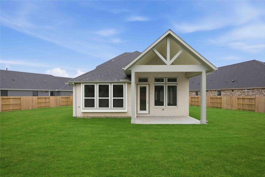 Exterior details and patio area of a home in Ellwood, Iowa Colony (Image 21).