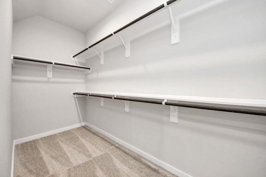 Walk-in closet that epitomizes luxury and practicality. This generously sizedspace features built-in shelving, offering abundant room for impeccableorganization. High ceilings and recessed lighting create a bright andwelcoming ambiance.