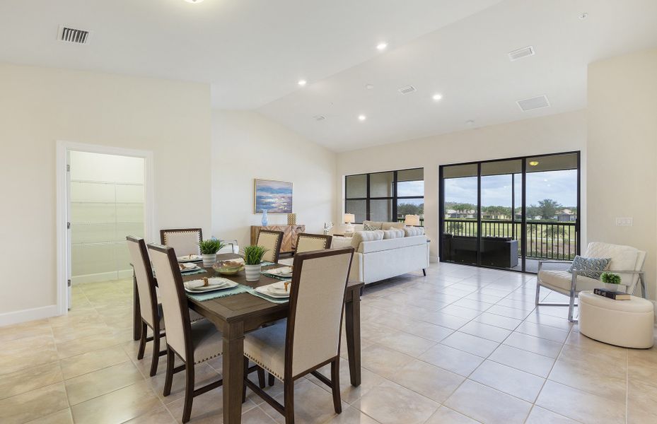 Open layout with connected gathering room, dining spaces, and kitchen