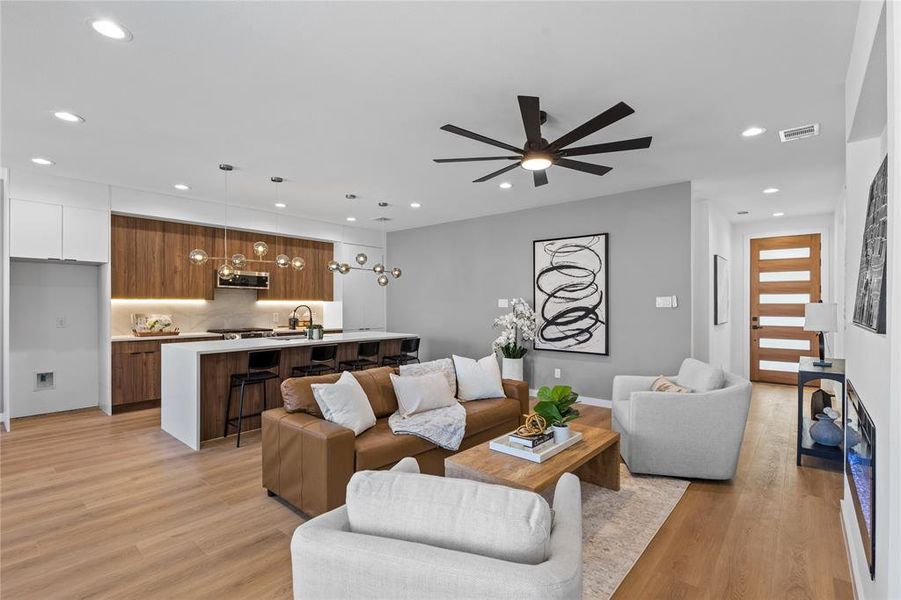 Living room featuring recessed lighting, light wood finished floors, and ceiling fan Living room featuring recessed lighting, light wood finished floors, and ceiling fan