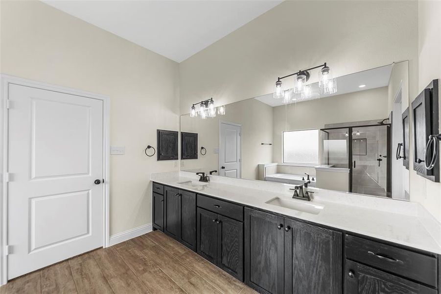 Dual vanity with dark wood-finish cabinetry and light countertops