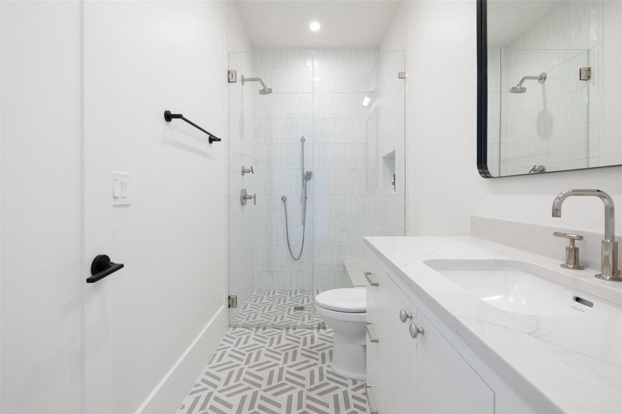 Full bathroom with vanity, a shower stall, light tile patterned floors, and recessed lighting Full bathroom with vanity, a shower stall, light tile patterned floors, and recessed lighting