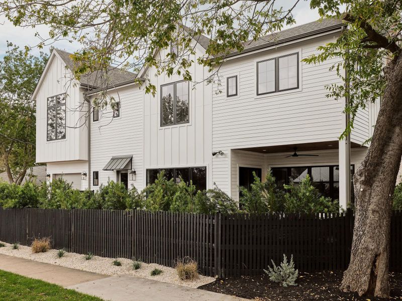 View of front of home featuring a fenced front yard, ceiling fan, a shingled roof, and board and batten siding View of front of home featuring a fenced front yard, ceiling fan, a shingled roof, and board and batten siding