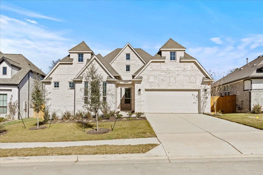 Front exterior of a new home in 6 Creeks, Kyle, TX, highlighting curb appeal (Image 2). Front exterior of a new home in 6 Creeks, Kyle, TX, highlighting curb appeal (Image 2).