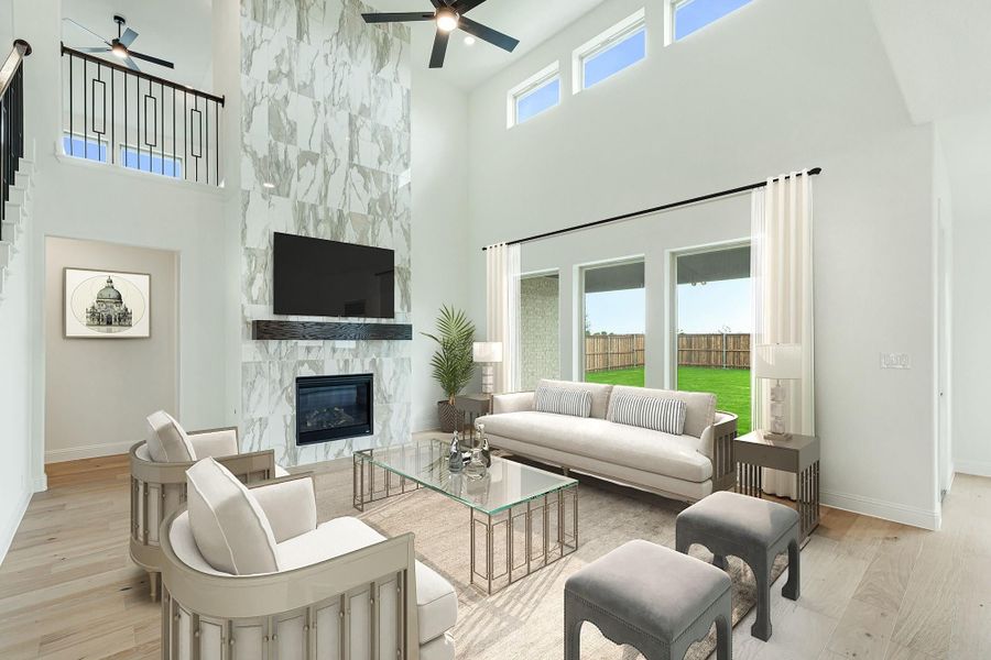 Living room with two-story ceiling, marble fireplace wall, mounted TV, and large windows with backyard view.