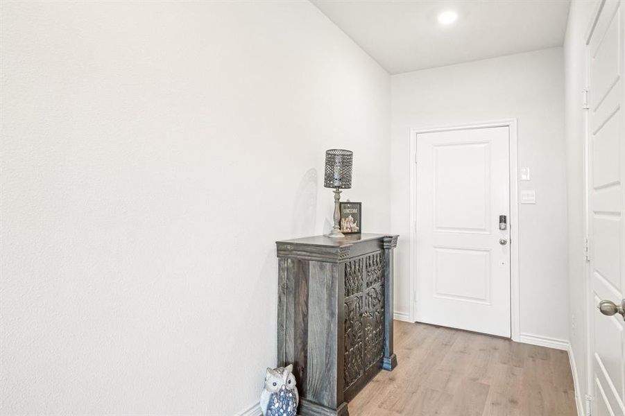 Hall featuring light wood-type flooring and recessed lighting Hall featuring light wood-type flooring and recessed lighting