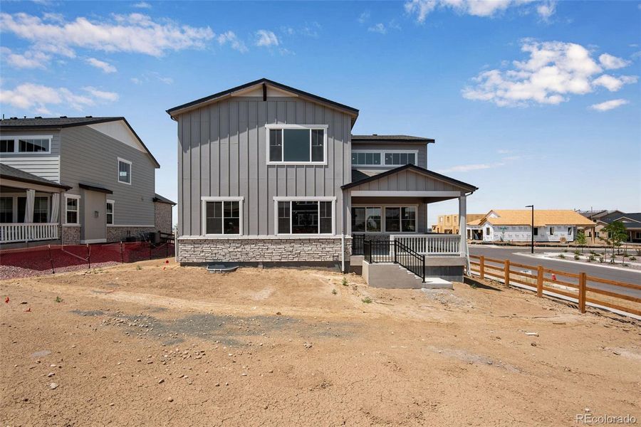 Front exterior of a new home in Ensemble at The Aurora Highlands, Aurora, CO, highlighting curb appeal (Image 22).