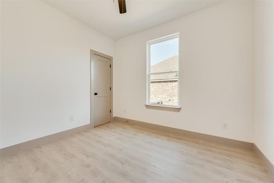 Unfurnished room with light hardwood / wood-style flooring and ceiling fan