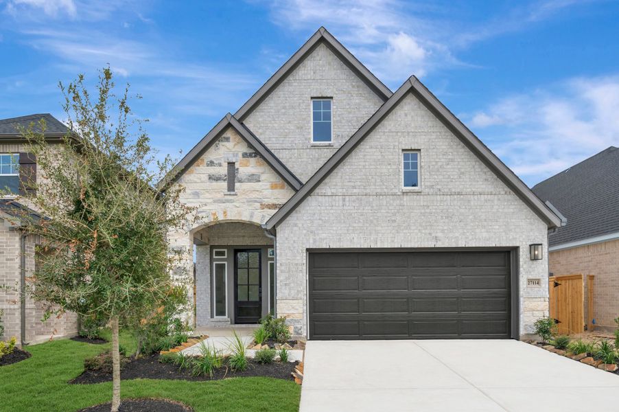 Front exterior of a new home in The Grand Prairie - Meadow Collection, Hockley, TX, highlighting curb appeal (Image 1). Front exterior of a new home in The Grand Prairie - Meadow Collection, Hockley, TX, highlighting curb appeal (Image 1).