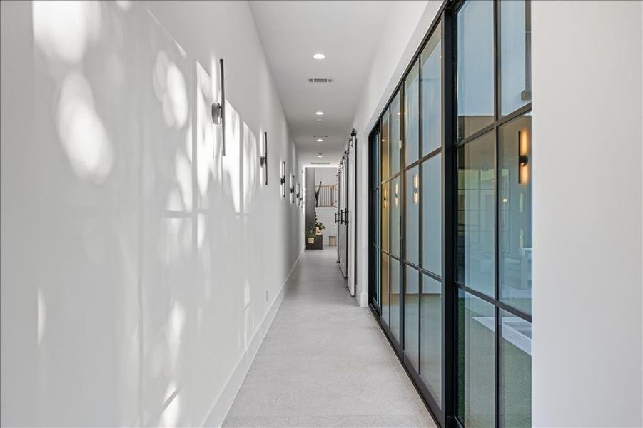 Hallway with recessed lighting and baseboards