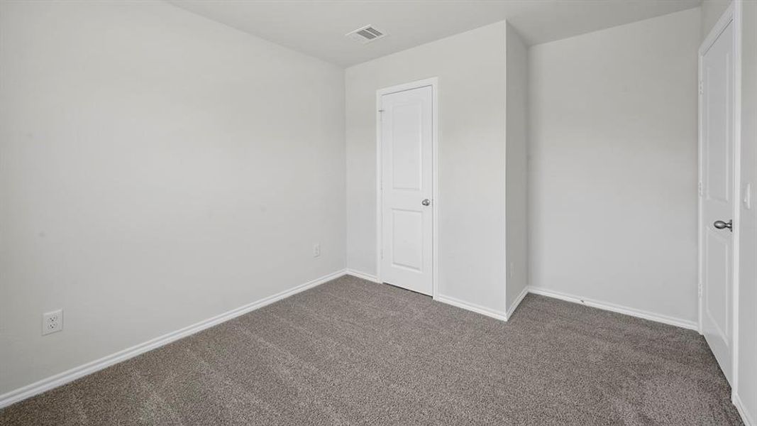 Unfurnished bedroom with carpet floors and baseboards