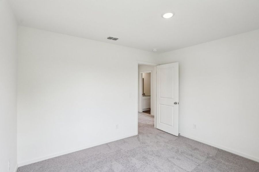 A hallway with white doors.