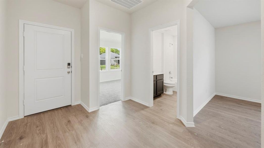Entryway featuring baseboards and light wood-type flooring Entryway featuring baseboards and light wood-type flooring