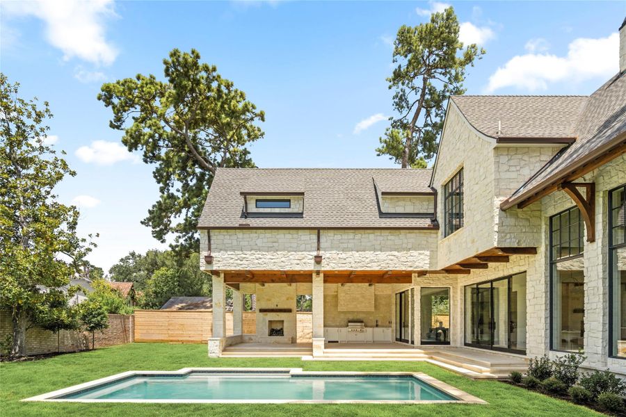 The covered loggia features a summer kitchen and fireplace overlooking the pool and lawn, with exposed wood beams and expansive glass doors connecting to the interiors. Enhanced photo. Existing overhead power lines are scheduled to be relocated underground. The covered loggia features a summer kitchen and fireplace overlooking the pool and lawn, with exposed wood beams and expansive glass doors connecting to the interiors. Enhanced photo. Existing overhead power lines are scheduled to be relocated underground.