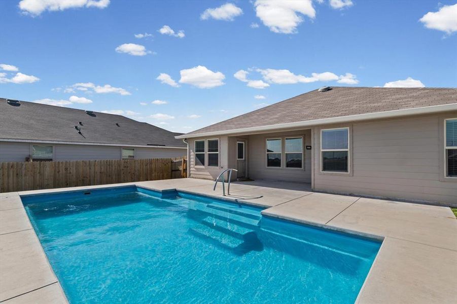 View of pool featuring a patio and a fenced backyard