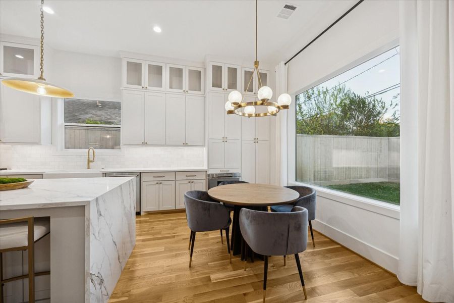 Natural light pours into the breakfast area through oversized windows, creating an easy, everyday dining space just off the kitchen. Proximity to the island and backyard keeps meals casual and connected while maintaining clear flow for morning routines and informal gatherings. Natural light pours into the breakfast area through oversized windows, creating an easy, everyday dining space just off the kitchen. Proximity to the island and backyard keeps meals casual and connected while maintaining clear flow for morning routines and informal gatherings.