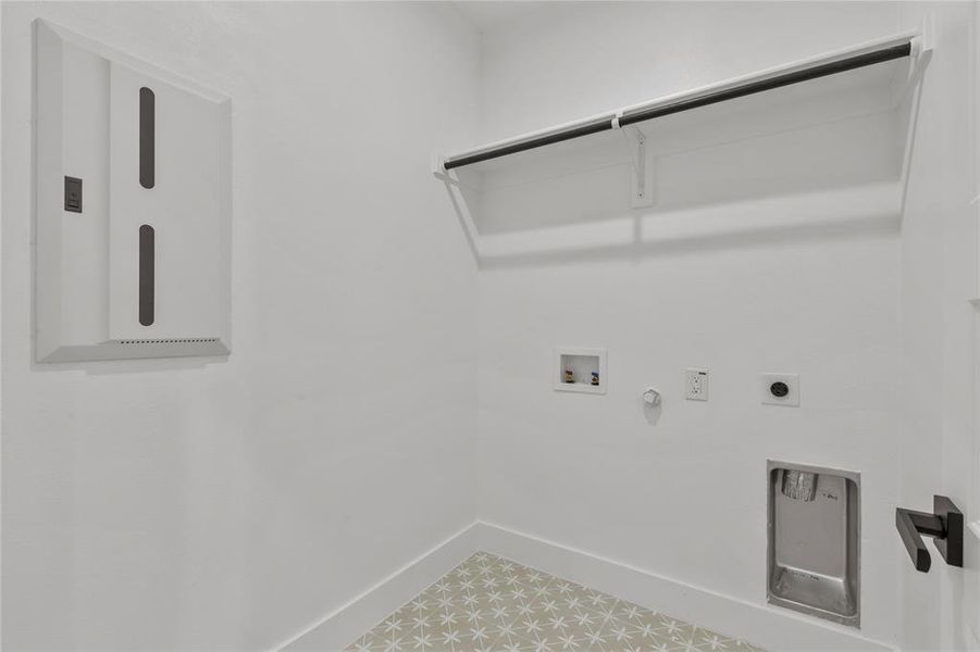 The laundry area features light-colored patterned floor tiles, white walls, and a clothes hanging rod with shelving