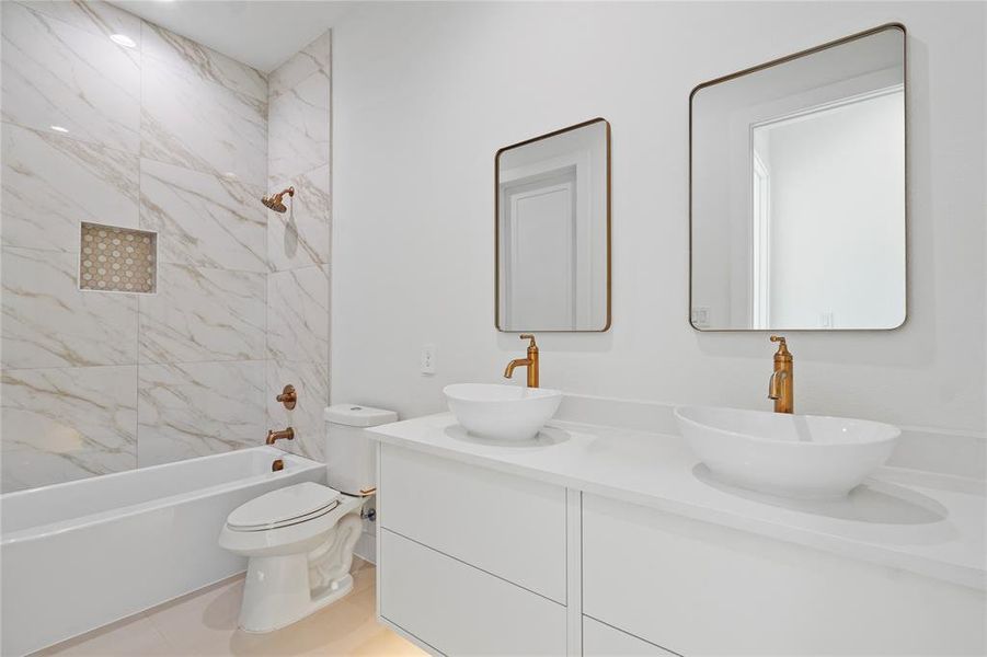 Bathroom featuring shower / bath combination and double vanity Bathroom featuring shower / bath combination and double vanity