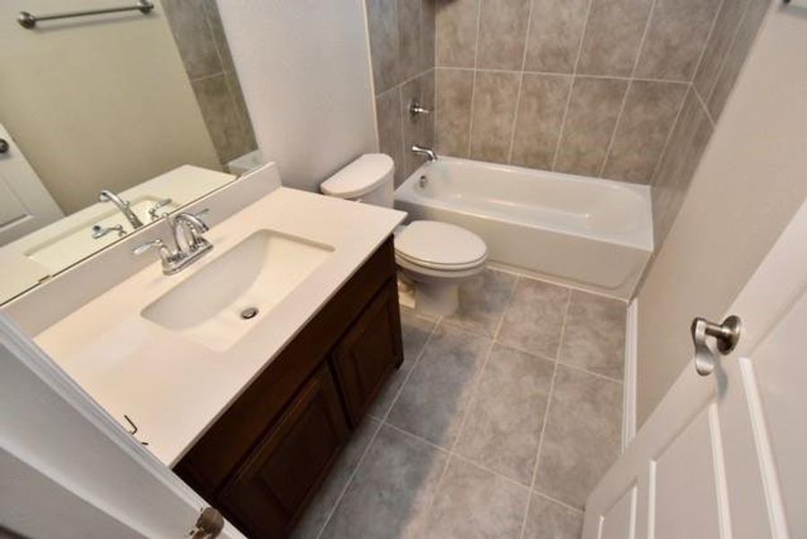 Full bathroom with light tile patterned floors, shower / bathtub combination, and vanity Full bathroom with light tile patterned floors, shower / bathtub combination, and vanity