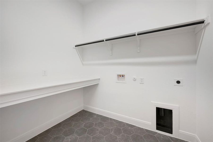 Laundry room featuring hookup for a gas dryer, washer hookup, electric dryer hookup, and dark tile patterned floors