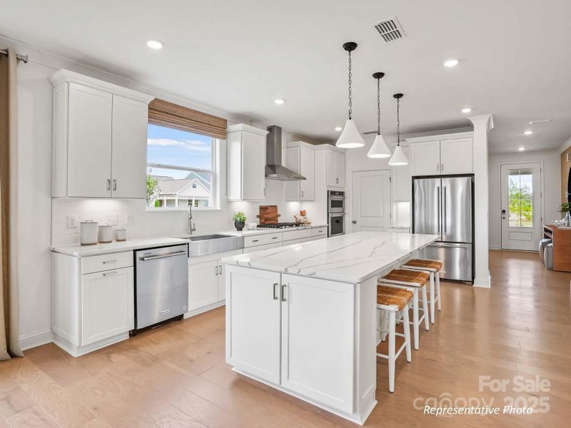 Luxurious gourmet kitchen with gas cooktop, oversized island, and large walk-in pantry Luxurious gourmet kitchen with gas cooktop, oversized island, and large walk-in pantry