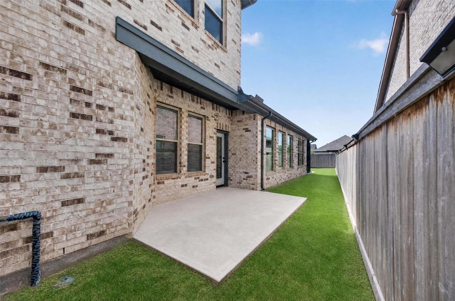 Tastefully tucked along the side of the home, this charming courtyard-style patio offers a peaceful escape for morning coffee, evening conversations, or effortless outdoor entertaining. Designed as a natural extension of the home's living space, it blends privacy, comfort, and versatility, creating an inviting setting to relax and enjoy the Texas lifestyle year-round.