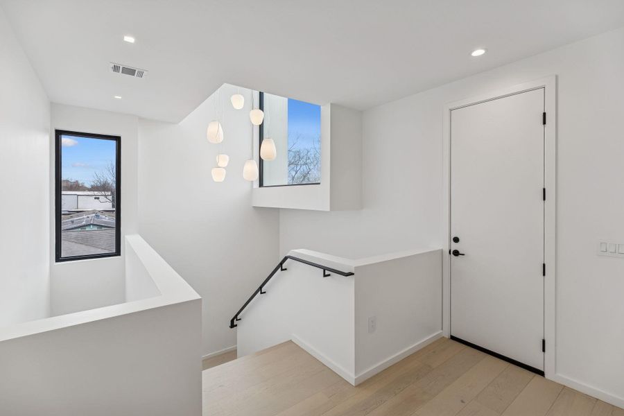 Entryway with light wood-type flooring and recessed lighting