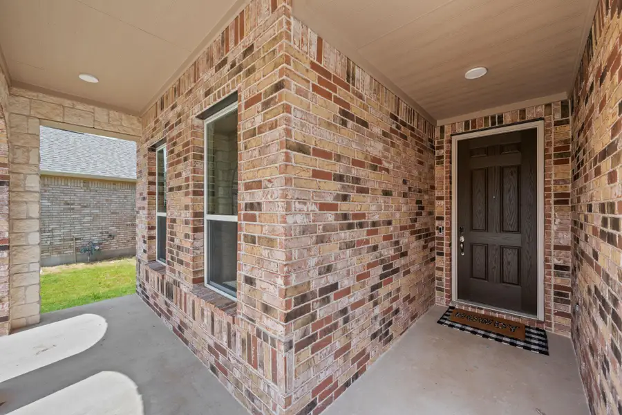 Entrance to property with brick siding and covered porch Entrance to property with brick siding and covered porch