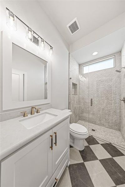 Bathroom with vanity, a stall shower, and dark flooring