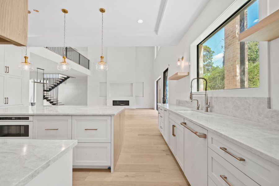 Chef's kitchen featuring premium Cafe appliances, quartzite countertops and custom cabinetry.