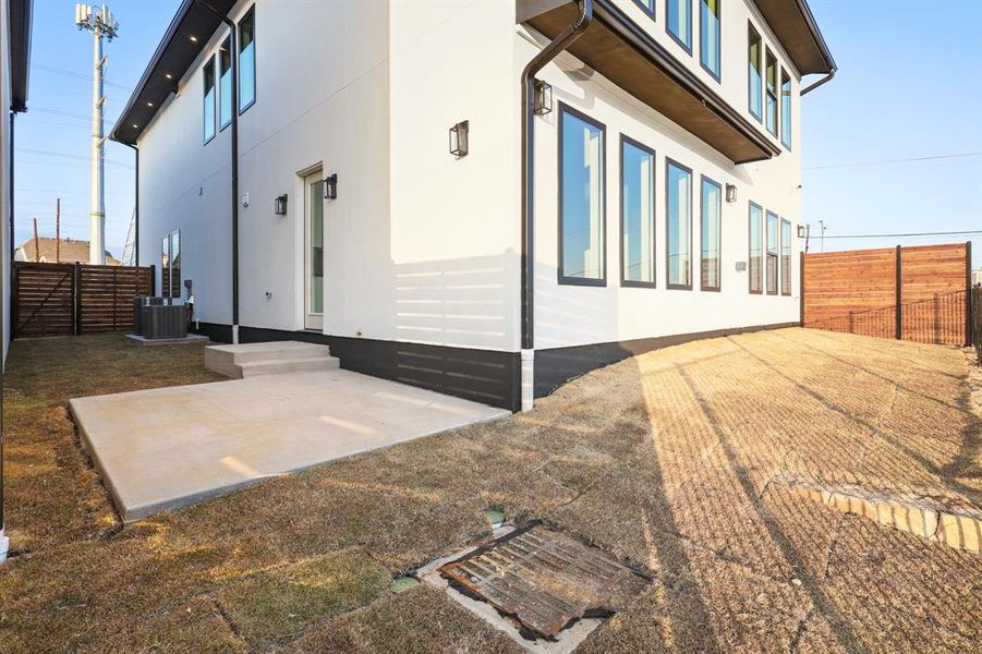 View of side of property featuring a patio and cooling unit