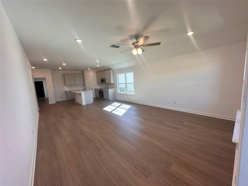 Unfurnished living room with recessed lighting, dark wood-style floors, and ceiling fan Unfurnished living room with recessed lighting, dark wood-style floors, and ceiling fan