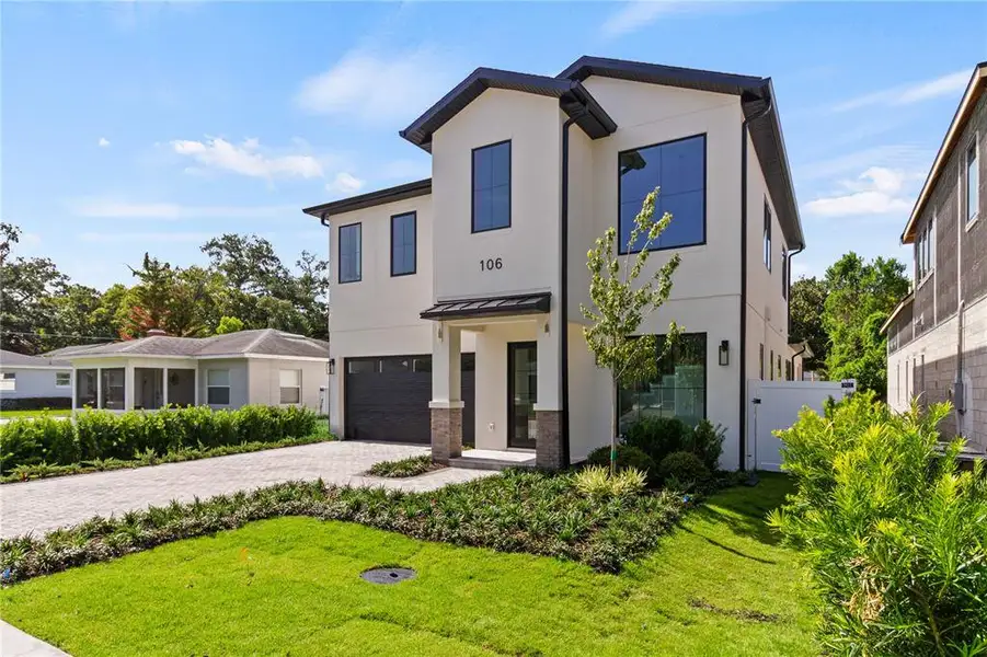 Front exterior of a new home in , Orlando, FL, highlighting curb appeal (Image 2).