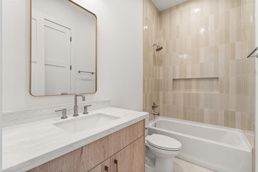 A tub-shower combo and a well-sized vanity make this a genuinely functional bath for family or guests, not just a token add-on. Clean tile work keeps it feeling fresh and low-maintenance.
