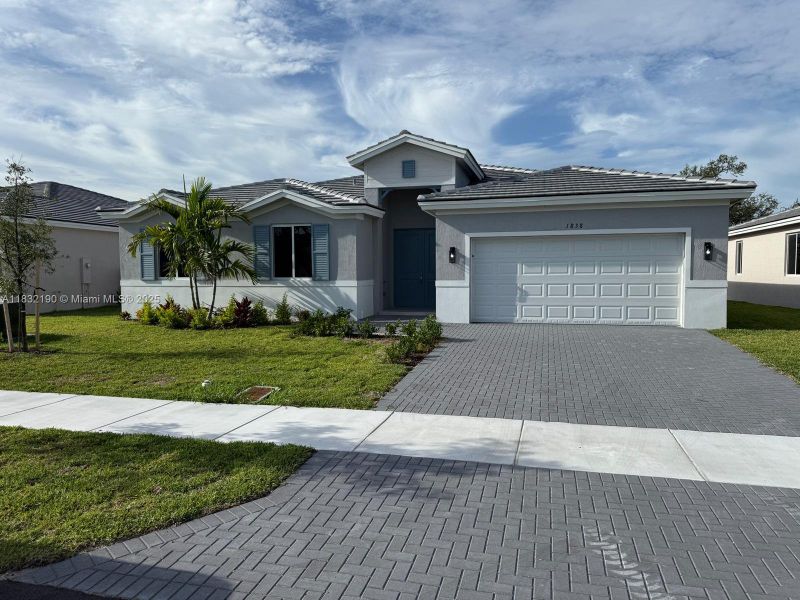 Front exterior of a new home in , Homestead, FL, highlighting curb appeal (Image 1). Front exterior of a new home in , Homestead, FL, highlighting curb appeal (Image 1).